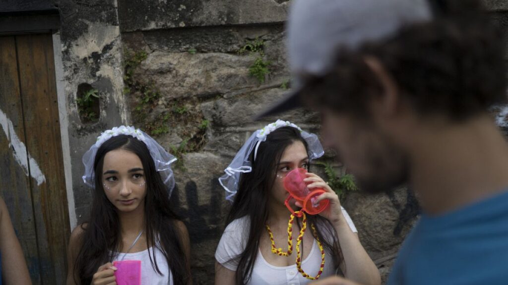 Revelers wearing bride costumes attend the Carmelitas street party in Rio de Janeiro, Brazil, Friday, Feb. 24, 2017.