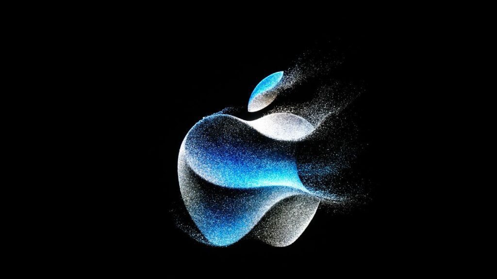The Apple logo is shown on a screen during an announcement on the Apple campus.