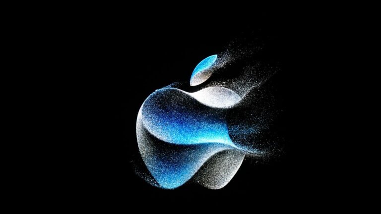 The Apple logo is shown on a screen during an announcement on the Apple campus.