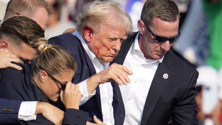 Republican presidential candidate former President Donald Trump is helped off the stage at a campaign event in Butler, Pa., on Saturday, July 13, 2024.