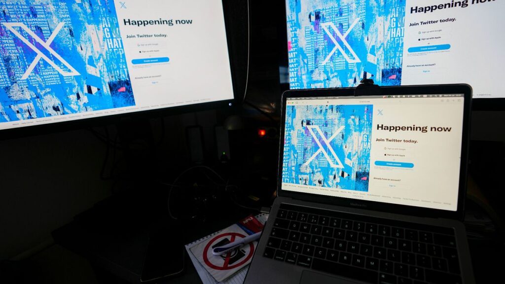 A view of a lap top and monitors showing the Twitter signing in page displaying the new logo, in Belgrade, Serbia, Monday, July 24, 2023