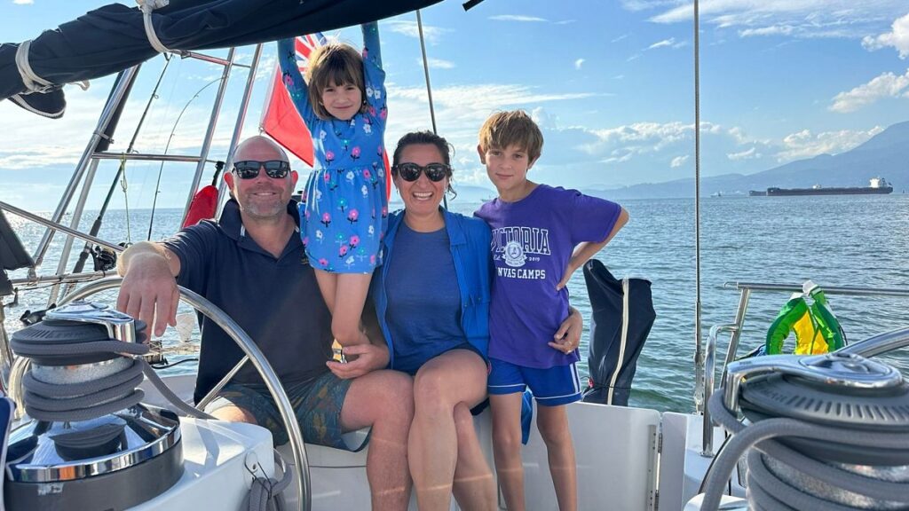 Larissa, Duncan, Skye and Eden hang out on their sailboat, Freeranger